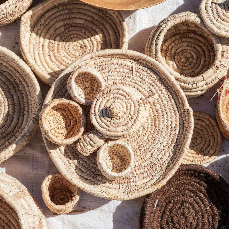 Handmade woven baskets and trays laid out together